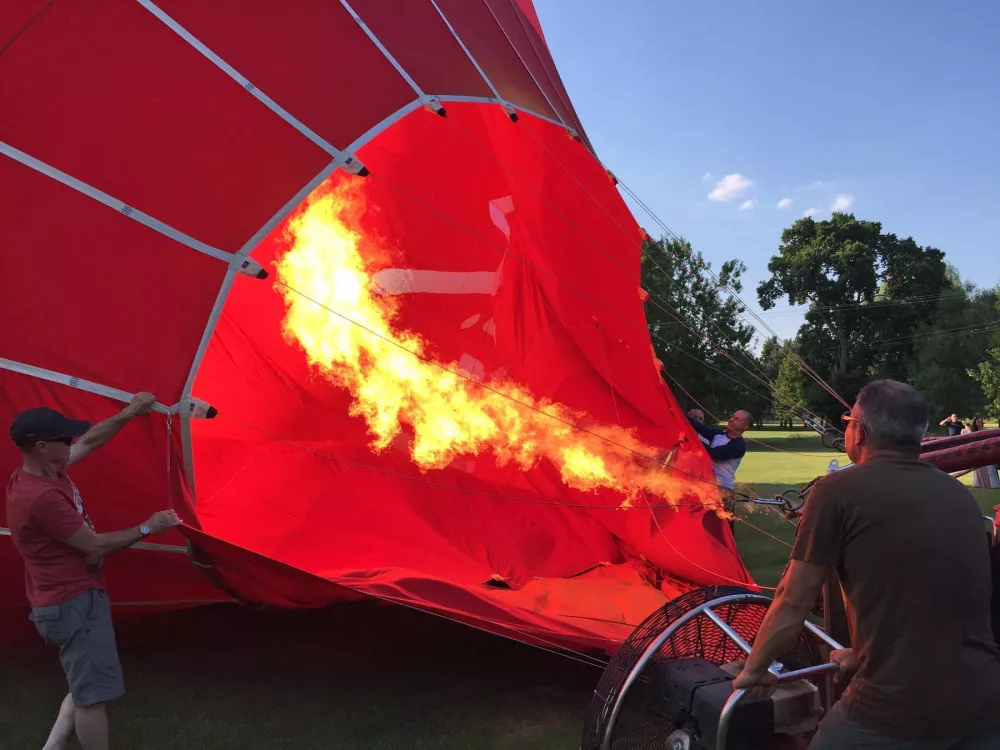 Passengers join in to inflate the hot air balloon